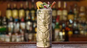 Cocktail Jet Pilot dans une tasse tiki sur un bar en bois